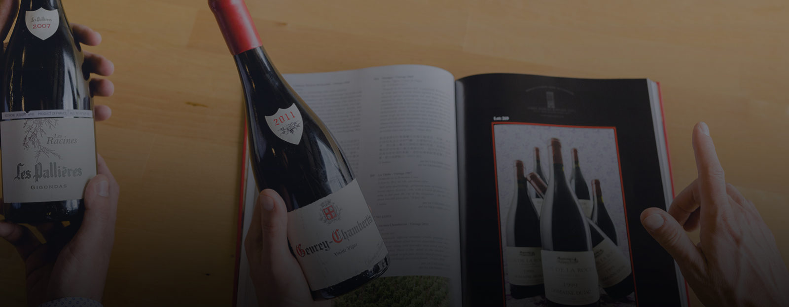 A wine bottle is compared to information in a catalogue for wine appraisals.